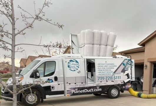 Planet Duct white truck parked in front of a house in Colorado Springs.